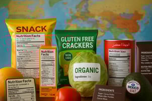 The image depicts a collage of various food labels from around the world showcasing a diversity of packaging styles and regulatory information In the foreground a colorful array of products includes snacks beverages and fresh produce each prominently-1